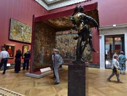 A room in a museum full with visitors