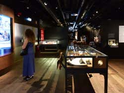 A woman in a blue dress walking around a musem