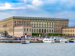 Royal Palace of Stockholm with reflective waterfront in the foreground